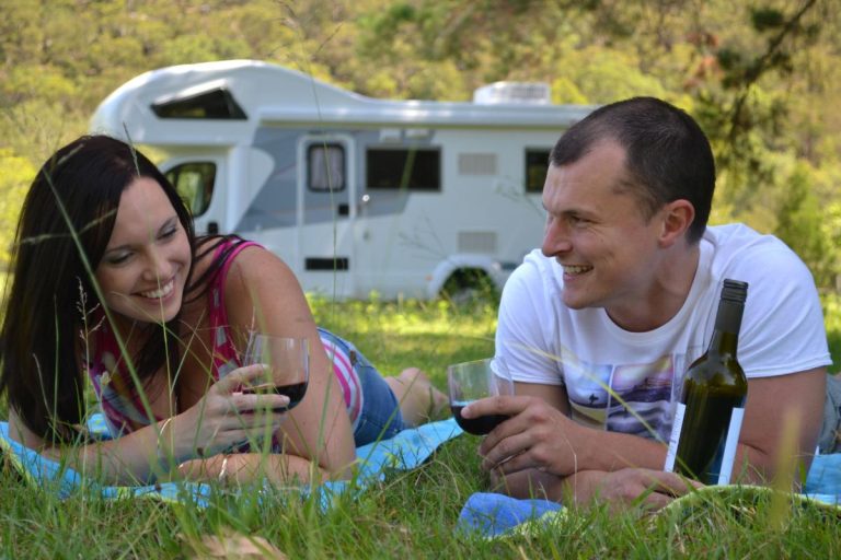 Couple relaxing with Avida luxury motorhome